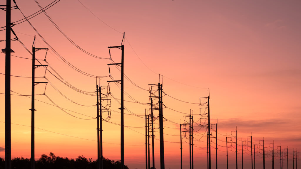 Power lines in front of a sunset