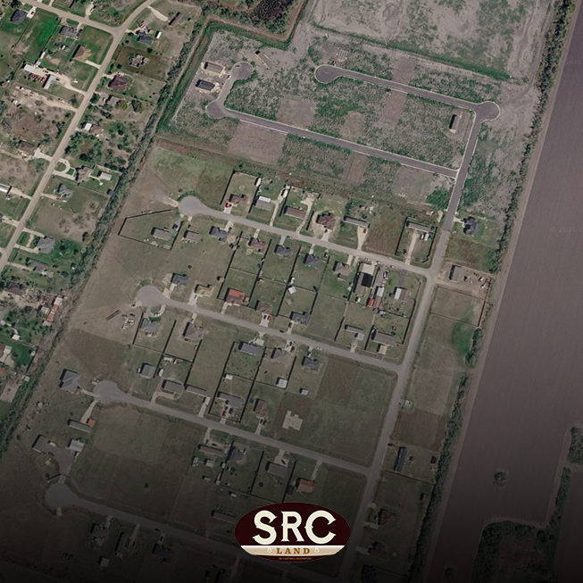 Aerial view of a suburban cul-de-sac neighborhood with many lots and houses, bordered by a river on the right; SRC Land logo at the bottom center.